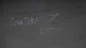 The image shows graffiti on a wall. The main text reads: **"This wall is owned by"** followed by a stylized spray-painted correction, changing “Great Thief” to a large **"Z"** with the name **"Zoro"** written inside it. In the top right corner, there's a smaller handwritten note that reads: **"three sword style!"**